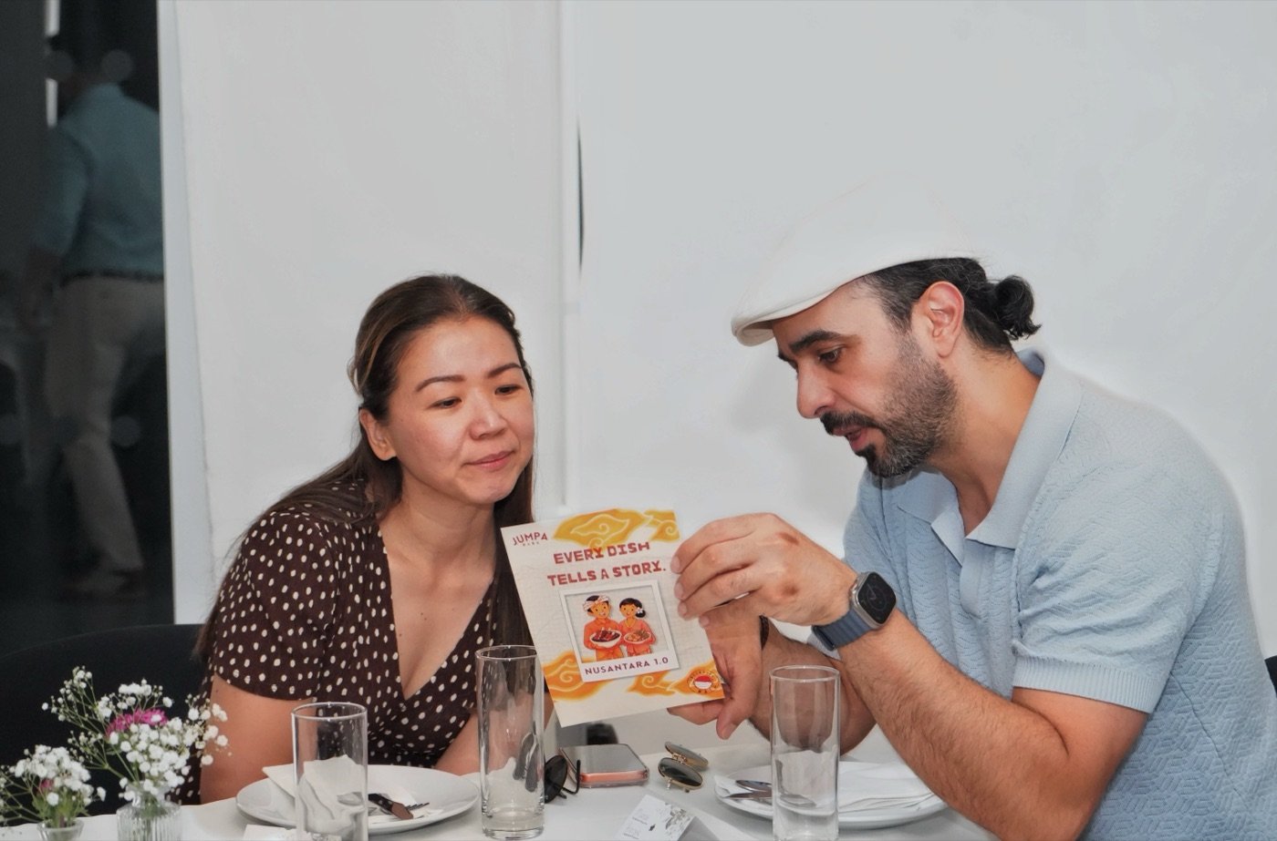 Guests looking over the Nusantara 1.0 menu card together at Jumpa Rasa