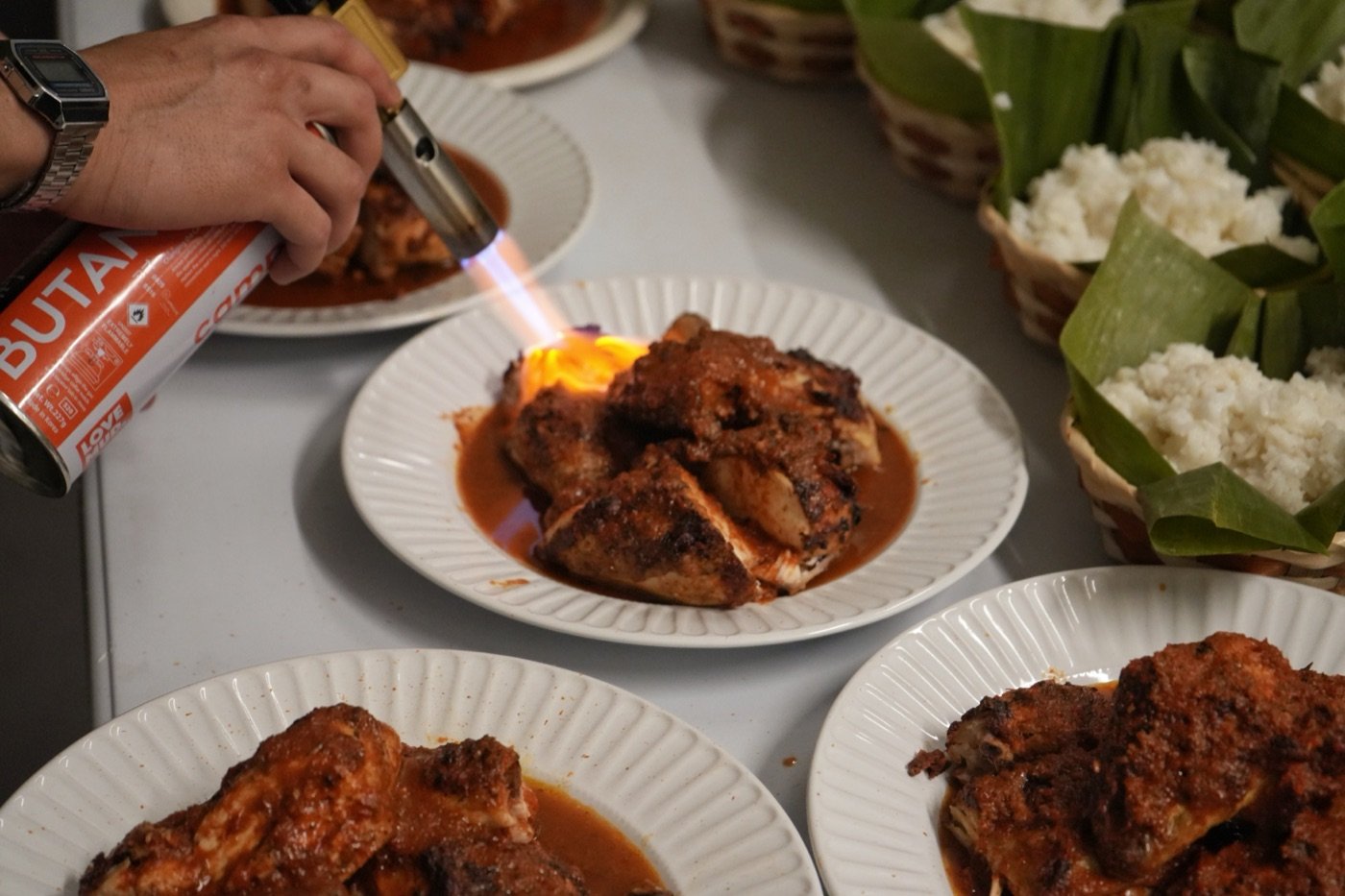Ayam Bakar Taliwang being flame-charred tableside